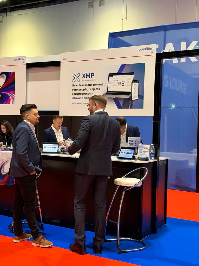 CEO Robin speaking with a visitor at the XMP stand.
